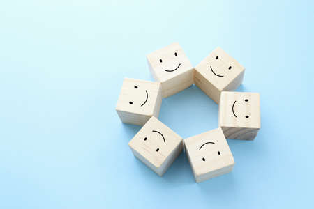 Concept image of satisfaction level. wooden cubes with emotionsの写真素材