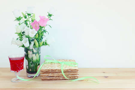 Passover background. Glass Wine cup and matzoh (jewish holiday bread)
