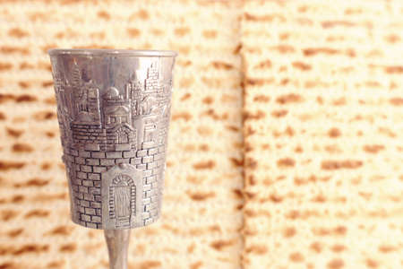 Passover background. Old Wine cup and matzoh (jewish holiday bread)
