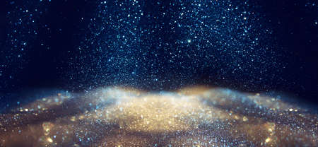 background of abstract gold, blue and black glitter lights. defocusedの写真素材
