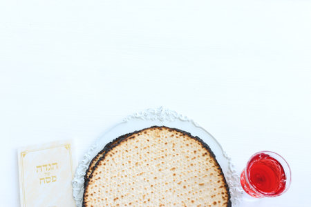 Pesah celebration concept (jewish Passover holiday). Traditional book with text in hebrew: Passover...