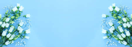 spring bouquet of white bell flowers over blue backgroundの写真素材