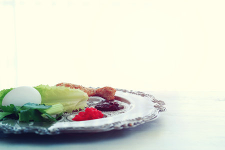 Passover background. Glass Wine cup and traditional plateの写真素材