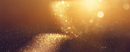 background of abstract gold and black glitter lights. defocusedの写真素材