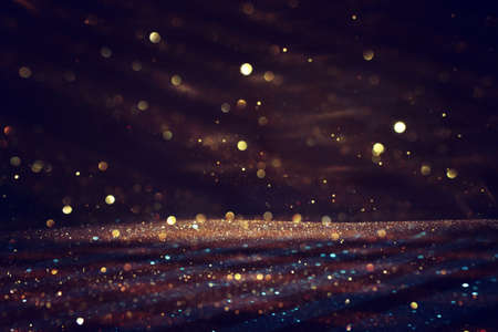 background of abstract gold and black glitter lights. defocusedの写真素材