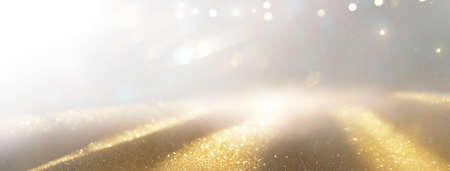 glitter vintage lights background. silver, gold and white. de-focused