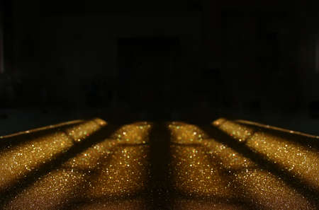 background of abstract gold and black glitter lights. defocused