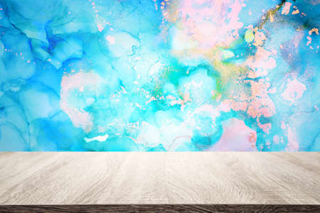 background of wooden table in front of abstract trendy painting. product display