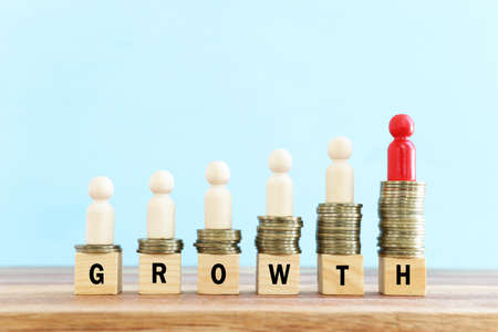 wooden cubes with stacked coins . growth and success conceptの写真素材