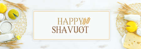 Top view photo of dairy products over white wooden background. Symbols of jewish holiday - Shavuotの写真素材