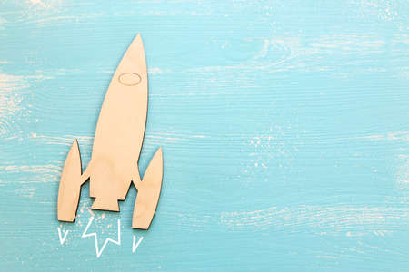 Top view image of wooden rocket toy over pastel background.の写真素材