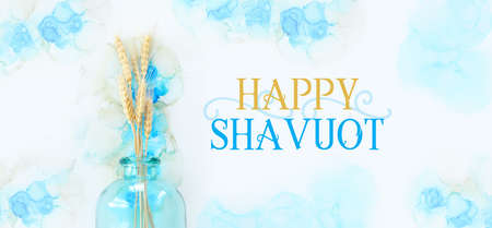 Creative image of beautiful wheat crops on artistic ink background. Top view with copy space. Symbols of jewish holiday - Shavuotの写真素材