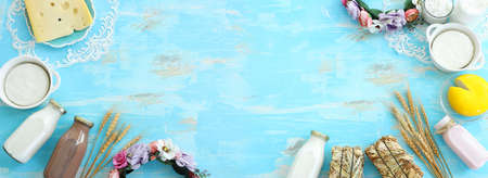 Top view photo of dairy products over blue wooden background. Symbols of jewish holiday - Shavuotの写真素材