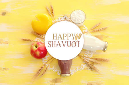 Top view photo of dairy products over yellow wooden background. Symbols of jewish holiday - Shavuotの写真素材