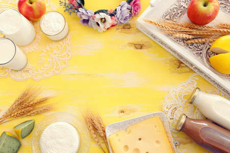 Top view photo of dairy products over yellow wooden background. Symbols of jewish holiday - Shavuotの写真素材