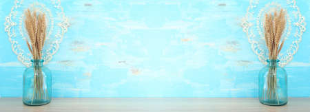 wheat crops over table and blue wooden background. Symbols of jewish holiday - Shavuotの写真素材