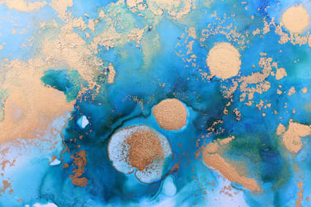 art photography of abstract fluid painting with alcohol ink, blue and gold colorsの写真素材