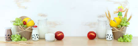 Photo of dairy products over wooden table. Symbols of jewish holiday - Shavuotの写真素材