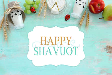 Top view photo of dairy products over blue wooden background. Symbols of jewish holiday - Shavuotの写真素材