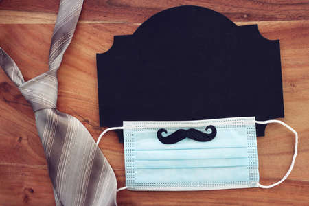 top view image of fathers day composition with vintage father's accessories, blackboard and protection face maskの写真素材