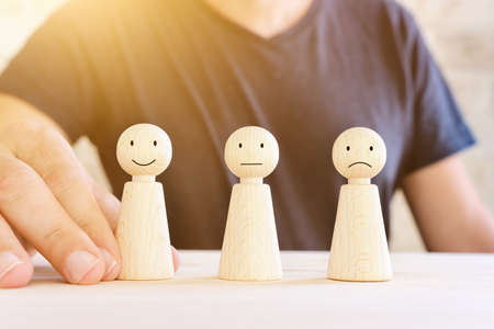 Concept image of satisfaction level. wooden people figures with emotionsの写真素材