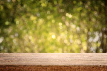 Empty rustic table in front of countryside background. product display and picnic concept
