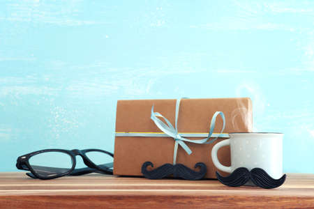 image of fathers day composition with hot cup of coffee over table and blue backgroundの写真素材