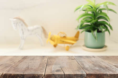 empty table board and defocused indoor background. product display concept