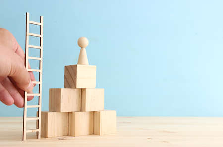 business concept image of people figures over wooden blocks and table, human resources and management conceptの写真素材