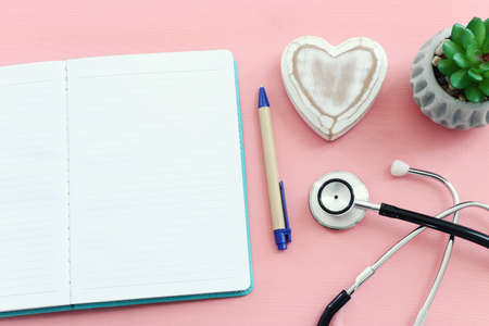 top view image of open notebook next to stethoscope