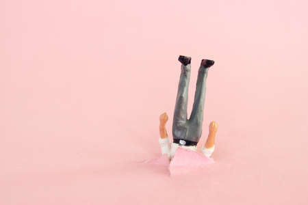 Funny image of man stuck upside downの写真素材