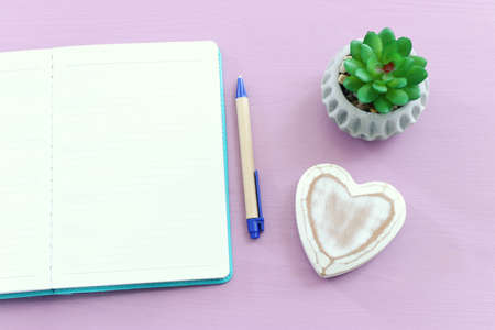 top view image of open notebook with blank pages on wooden table. ready for adding text or mockup.の写真素材