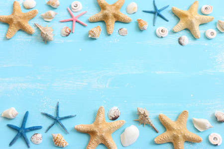 vacation and summer concept with seashells over blue wooden background. Top view flat layの写真素材