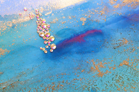 art photography of abstract fluid art painting with alcohol ink blue, aqua, gold colors and crystal...