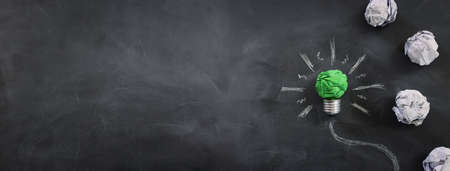 Concept image if green crumpled paper lightbulb, symbol of scr, innovation and eco friendly businessの写真素材