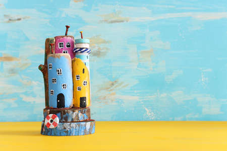 nautical concept with driftwood beach houses and lighthouse over wooden tableの写真素材