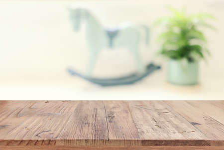 empty table board and defocused indoor background. product display concept