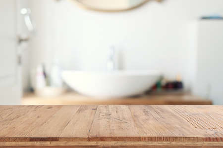 empty table board and defocused indoor bathroom background. product display conceptの写真素材
