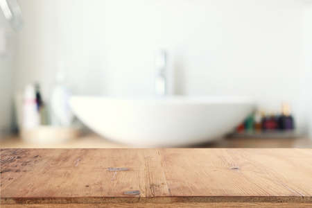 empty table board and defocused indoor bathroom background. product display conceptの写真素材