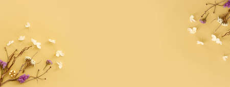 Top view image of flowers composition on pastel yellow background .Flat layの写真素材