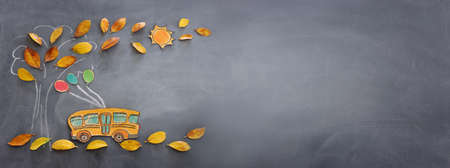 Back to school concept. Top view banner of school bus and pencils next to tree sketch with autumn...