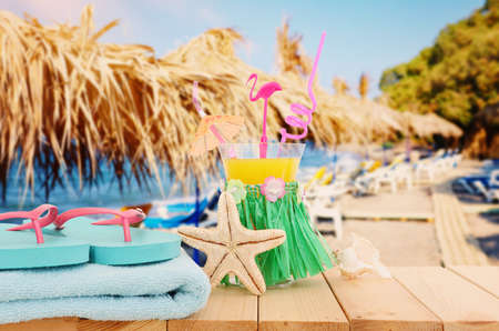 image of tropical and exotic fruit coctail over wooden table infront of sea landscape background