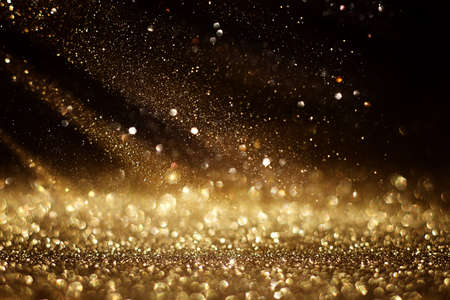 background of abstract gold and black glitter lights. defocusedの写真素材