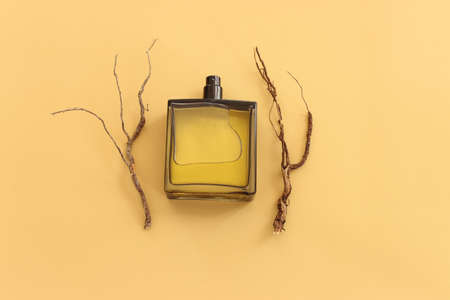 Top view of elegant perfume bottle with oud over yellow background. Cosmetics, fragrance and perfumery conceptの写真素材