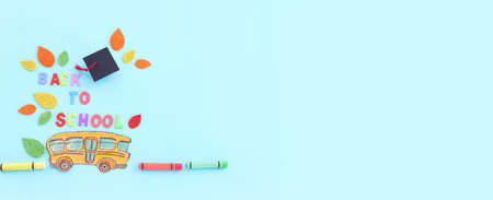 Back to school concept. Top view image of school bus over blue backgroundの写真素材