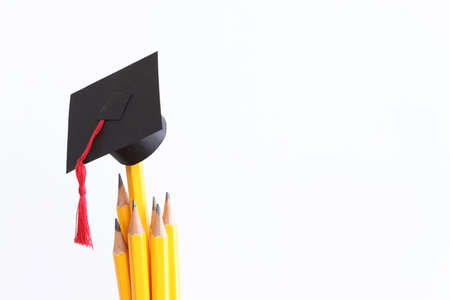 Image of education concept. Traditional graduation hat over pencilsの写真素材