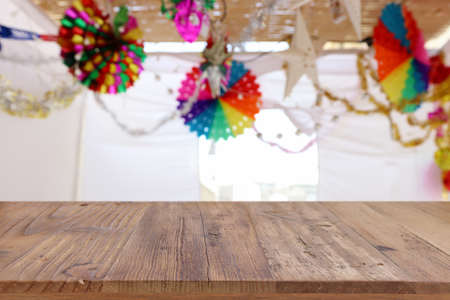 Jewish festival of Sukkot. Traditional succah (hut) with decorations. Empty wooden old table for product display and presentation.の写真素材