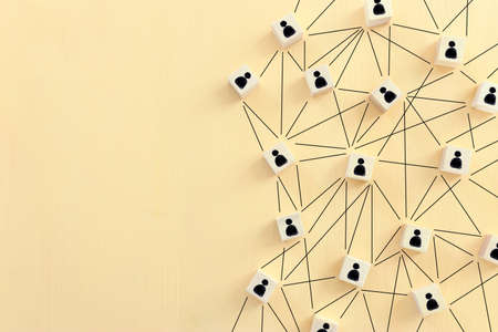 image of tangram blocks with people icons over wooden table ,human resources and management conceptの写真素材