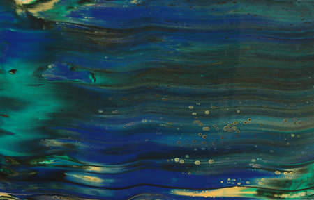 art photography of abstract marbleized effect background. Black, gold, blue and green creative...