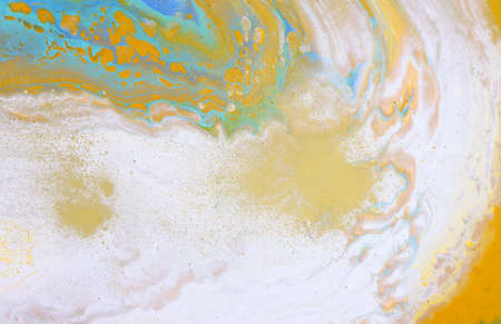 art photography of abstract marbleized effect background with white, blue and yellow reative colors....